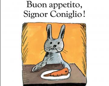 coniglio di fronte ad un piatto con una carota